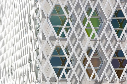 Abstract view of a auditorium facade showcasing geometric patterns of interlocking diamond shapes