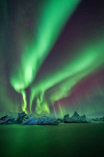 Northern Lights over icebergs in the glacier lagoon, Jökulsarlon, icebergs with glacier,