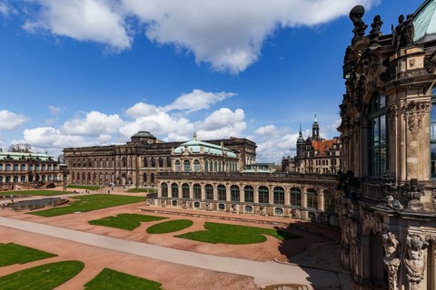 The Zwinger Palace in Dresden, Germany, showcases its stunning baroque architecture under a vibrant
