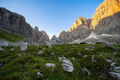 Picturesque mountain landscape in Val Brenta Alta at sunrise, rocky peaks of Cima Tosa,