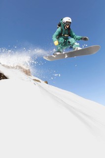 A snowboarder expertly navigates a thrilling freeride descent, capturing the essence of extreme