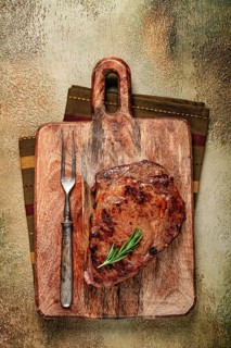 Grilled steak, beef steak, rib eye steak, on a chopping board, top view, no people