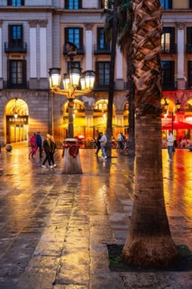 Nightlife at Plaça Reial, lanterns by Gaudi in the historic centre of Barcelona, Spain