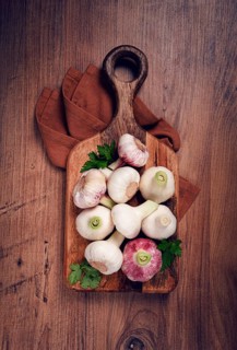Fresh young garlic, white and purple color, on a wooden table, no people