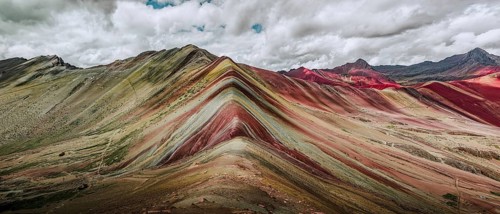 A stunning panoramic capture of Vinicunca, or Rainbow Mountain, famous in Peru for its colorful,