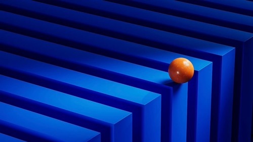 An orange sphere rests on a series of blue geometric shapes, creating an engaging abstract