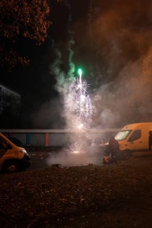 Nocturnal fireworks spectacle on a street with spectators and smoke, Stuttgart Birkach, Germany