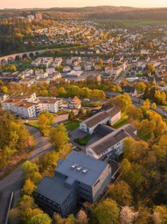 Aerial view of an urban area with houses and trees in a hilly landscape, Nagold, Black Forest,