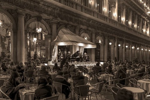Music orchestra playing in front of the historic Café Florian on St. Mark's Square in the evening,