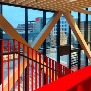 Staircase with signal red color scheme in seminar building H of Bochum University in the evening