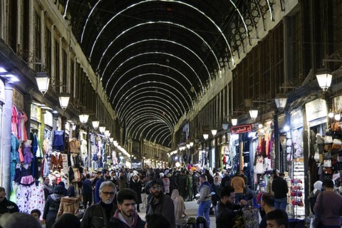 Syrians shop at the historic Al-Hamidiyah Bazaar adjacent to the Umayyad Mosque during the early