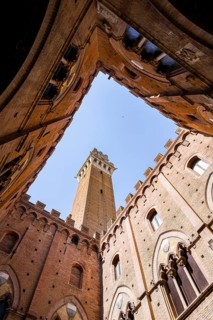 Upwards view of Torre del Mangia from inside Palazzo Pubblico, Siena, Tuscany, Italy