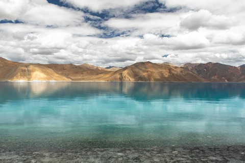 A stunning view of Pangong Tso lake in Ladakh, India, with its crystal-clear turquoise waters