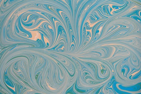 An abstract floral pattern with swirling blue and beige acrylic paint. This dynamic design creates