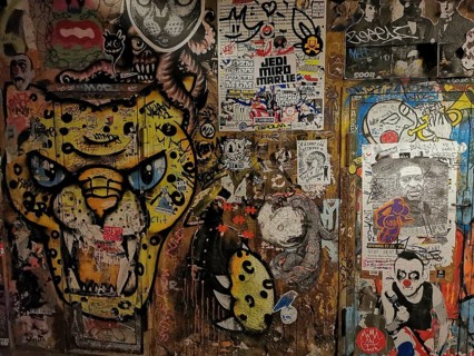 Colourful graffiti and poster wall with lively urban works of art, Berlin