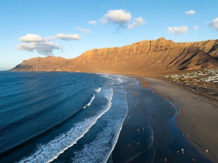 Risco de Famara cliffs and sea with Famara beach, in the evening light, Playa de Famara, aerial