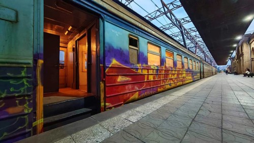 A graffiti-decorated train on the platform at dusk, Yerevan, Armenia