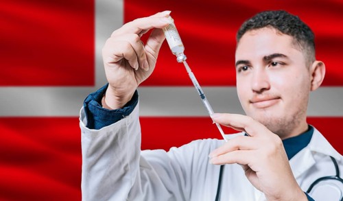 Doctor holding syringe on Denmark flag background. Medical professional holding syringe with Danish