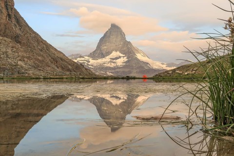Stunning landscape of the Matterhorn reflected in a serene alpine lake, surrounded by the majestic