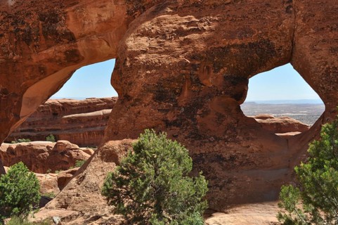 Sandstone formations with double windows offer spectacular views of the desert, Arches National