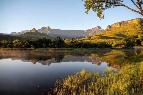 Sunrise, amphitheatre with reflection in the lake, Royal Natal National Park, Drakensberg Mountains