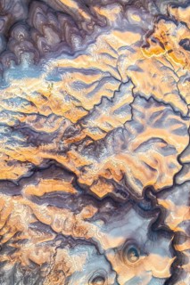 Aerial capture of Utah's stunning golden bentonite formations, showcasing their unique patterns and