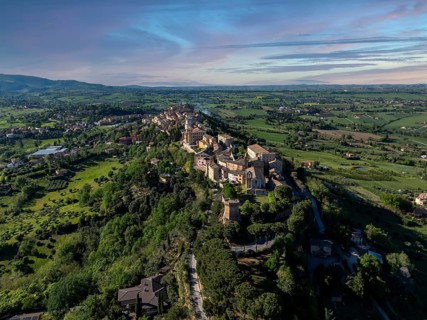 Breathtaking aerial view of Treia, Italy, showcasing historic architecture amid lush greenery and
