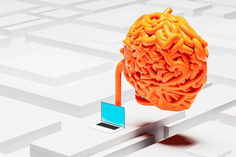 Colorful cables intertwine around a laptop, creating a striking contrast against a monochromatic