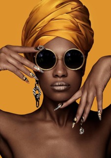 Beautiful black woman with a yellow towel on her head, classic makeup and art manicure. Beauty face