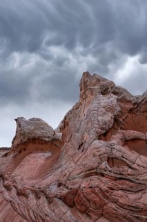 Majestic, swirling rock formations at White Pocket, Arizona, USA, set against a backdrop of dark,