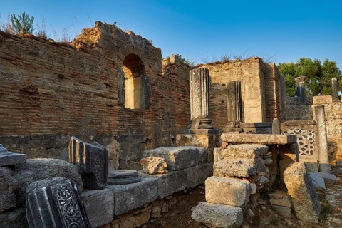 Phidias' workshop, ancient ruins with decorative columns against the blue sky, archaeological site,