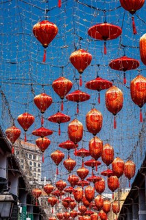 From below a captivating display of vibrant red lanterns adorned with Chinese characters, suspended