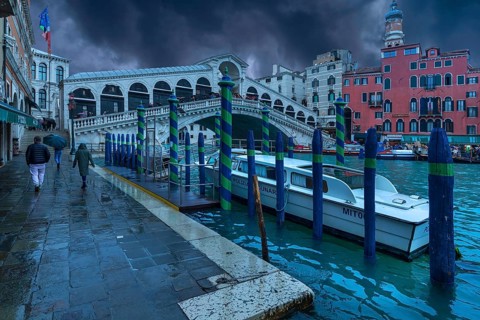 Rain clouds over the Rialto Bridge, a police boat anchored in front, Venice, Veneto, Italy