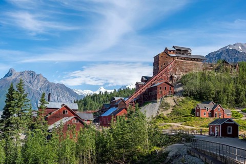 Red Kennicott buildings in front of mountainous landscape, Kennicott Concentration Mill to extract