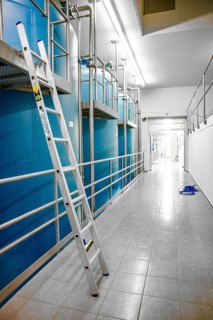 Long corridor with blue walls and a ladder on the side, ENCW Netze Calw waterworks, Calw, Black