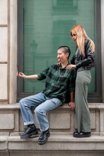 A Colombian lesbian couple enjoys a day out, capturing joyful moments together. Embracing love,