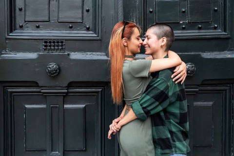 A Colombian lesbian couple lovingly embraces, symbolizing unity and diversity. Their affectionate