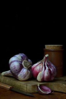 Fresh red garlic on chopping board, France