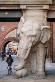 Bicyclist, monumental stone elephant, Elephant Gate or Elephant Portal or Elefantporten, by