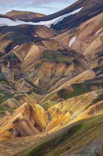 Small river between colourful rhyolite mountains, volcanic landscape, colourful erosion landscape,