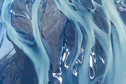 Stunning aerial drone photograph showcasing the complex, natural river patterns and icy textures