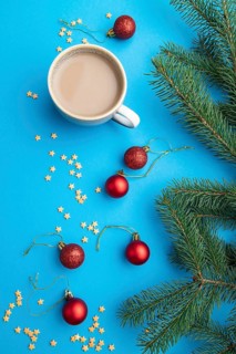 Christmas or New Year composition. Decorations, red balls, fir and spruce branches, cup of coffee,