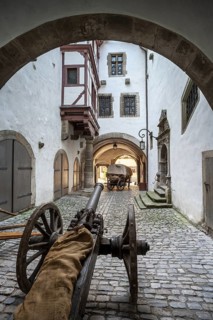 Cannon and horse-drawn carriage in the inner courtyard of the Gothic part of the town hall, Old