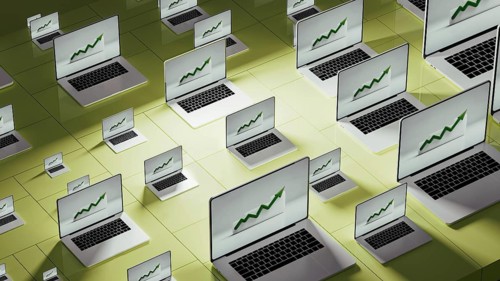 Multiple laptops showcase upward stock market trends in a modern business workspace, reflecting