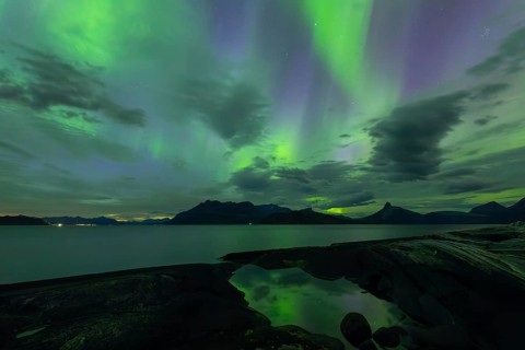 Northern lights at dawn over Sørfolda Fjord near Kjerringøy between Bodø and Sørfold in Norway