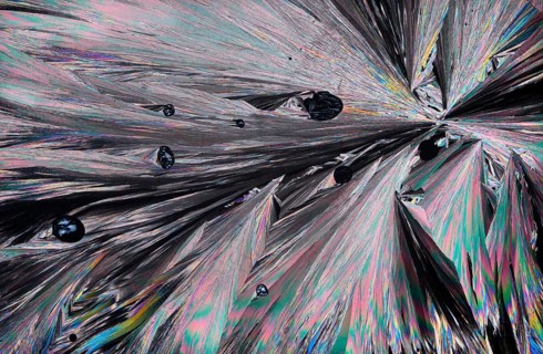 Stunning microscopic image showcasing the intricate patterns and vibrant colors of Hippuric acid