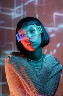 A Latin woman experiencing the immersive world of virtual reality. Wearing futuristic VR glasses,