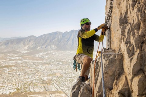 A man skillfully practices mountaineering and rappelling on the rugged cliffs of Eagleâ€™s Nest in