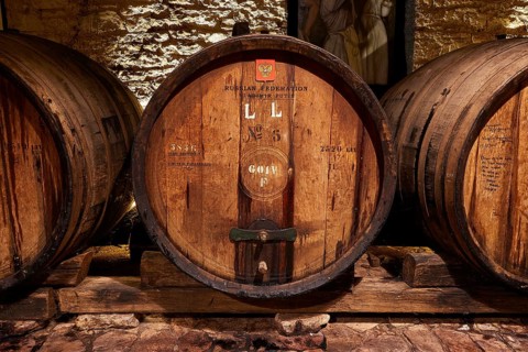Vladimir Putin wine barrel, detailed view of a wooden barrel in a historic wine cellar, Achaia