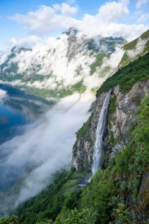 Gjerdefossen waterfall, at Ørnesvingen viewpoint, atmospheric clouds over the fjord in the morning